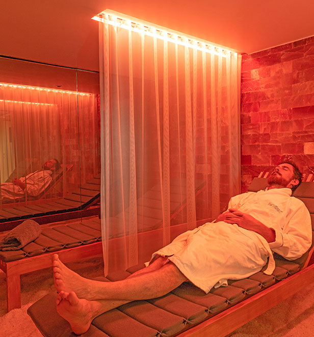 A man relaxing on a lounger in the Salt Therapy Lounge on the Scenic Sapphire ship.