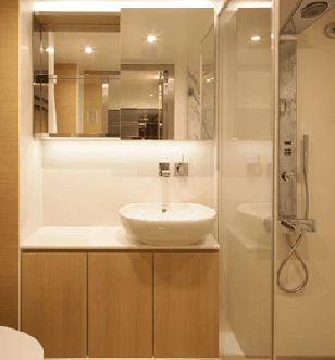 Luxurious bathroom in a Deluxe Balcony Suite with a shower, vanity and toilet. 