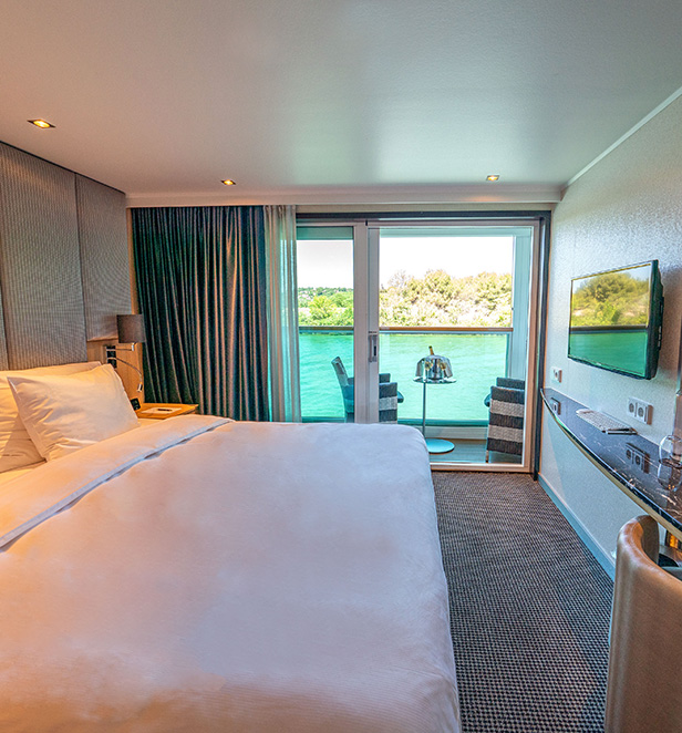  A Balcony Suite on the Scenic Sapphire ship with a plush Queen bed and Scenic Sun Lounge area.  