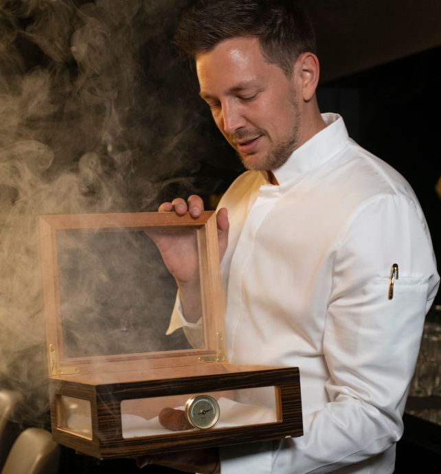 Chef Tom Goetter opening a smoking box