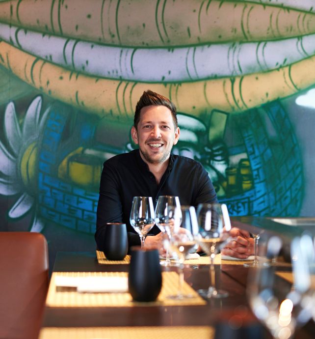 Chef Tom Goetter sitting at a table